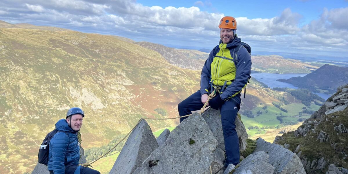 Guys sat on cantilever pinnacle-ridge-lake-district